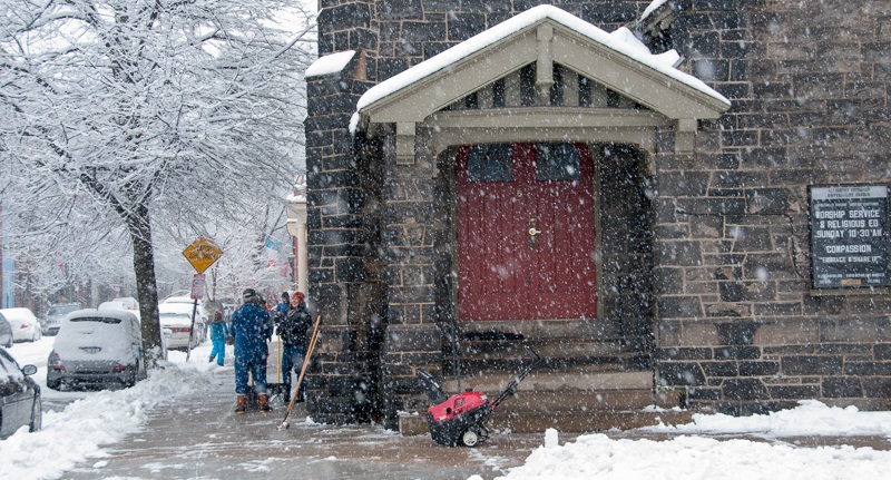 A snowy day shoveling walk at church